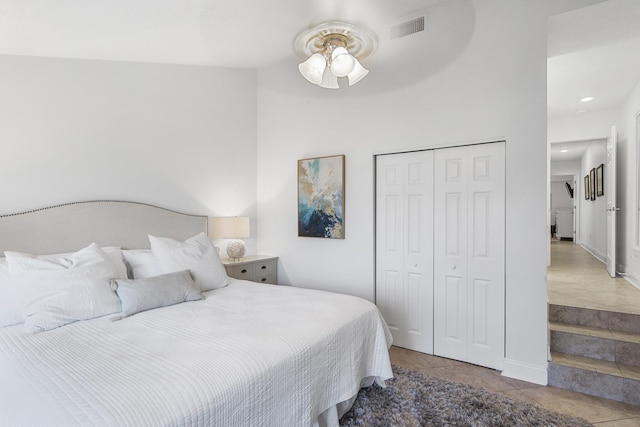 tiled bedroom with a closet and ceiling fan