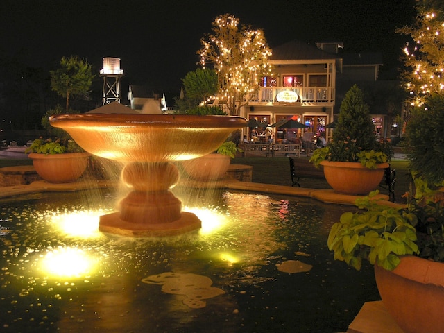 view of pool at twilight