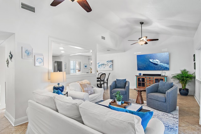 tiled living room featuring vaulted ceiling