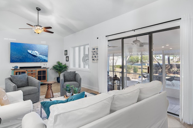 living room with ceiling fan and lofted ceiling