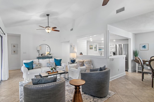 tiled living room featuring vaulted ceiling and ceiling fan