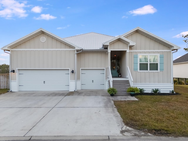 view of front of home with a front yard and a garage