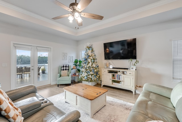 living room with ceiling fan, french doors, crown molding, and light wood-type flooring