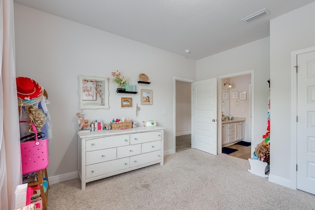 carpeted bedroom with connected bathroom