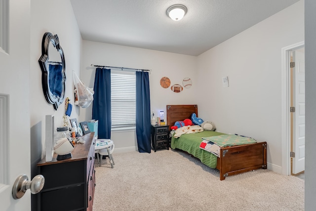 bedroom featuring carpet and a textured ceiling