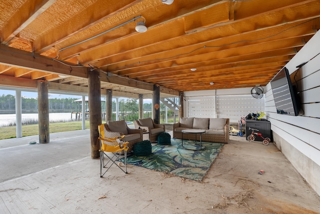 sunroom featuring a water view