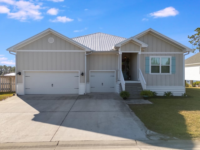 view of front of home featuring a front yard and a garage