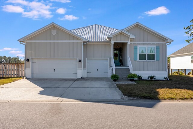 view of front of property with a garage and a front lawn