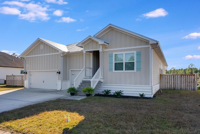 view of front of property with a front yard and a garage