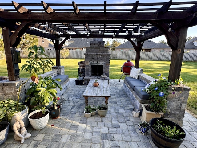 view of patio / terrace featuring a fenced backyard and an outdoor stone fireplace