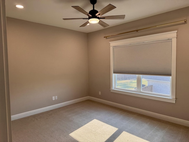 spare room with recessed lighting, carpet, a ceiling fan, and baseboards