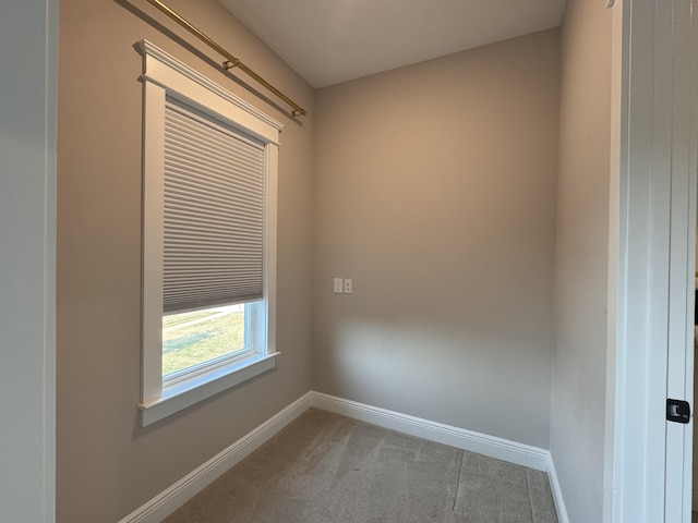 empty room with carpet and baseboards