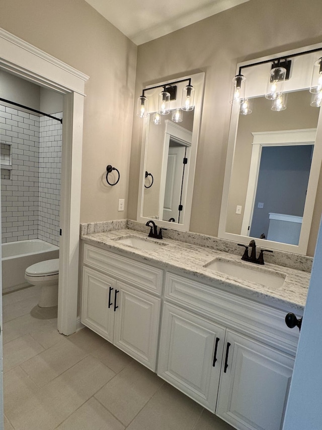 bathroom with double vanity, a sink, and tile patterned floors