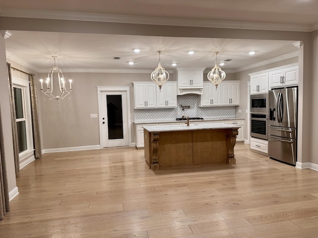 kitchen with light wood-type flooring, white cabinetry, appliances with stainless steel finishes, and a notable chandelier