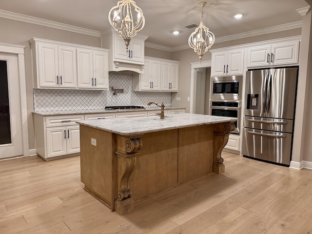 kitchen featuring stainless steel appliances, white cabinets, visible vents, and light wood-style floors