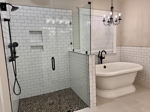 bathroom featuring a freestanding tub, tile patterned flooring, a wainscoted wall, tile walls, and a shower stall