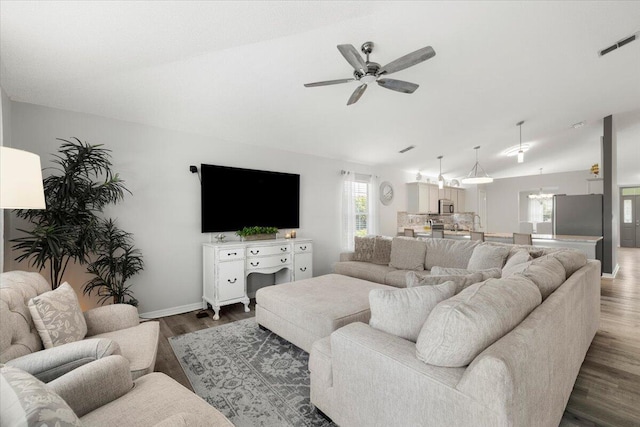 living room with vaulted ceiling, ceiling fan, and dark hardwood / wood-style flooring