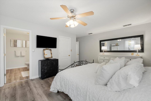 bedroom with light hardwood / wood-style flooring, ceiling fan, and ensuite bathroom