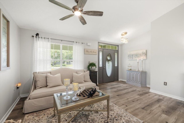 living room featuring hardwood / wood-style floors and ceiling fan