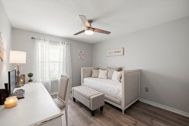 bedroom featuring ceiling fan, dark wood-type flooring, and a textured ceiling