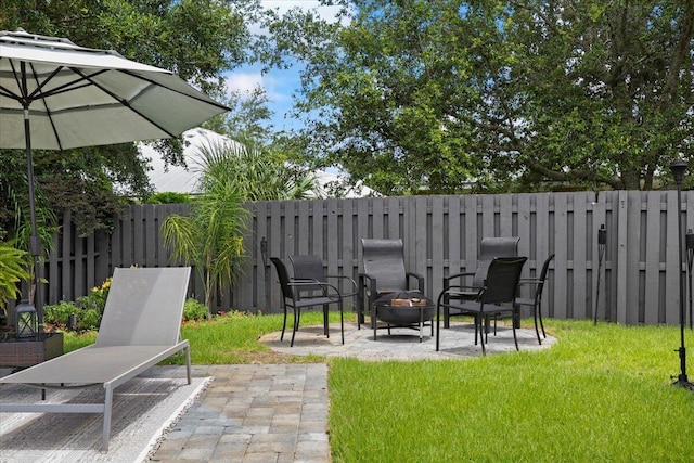 view of yard featuring a patio area and an outdoor fire pit