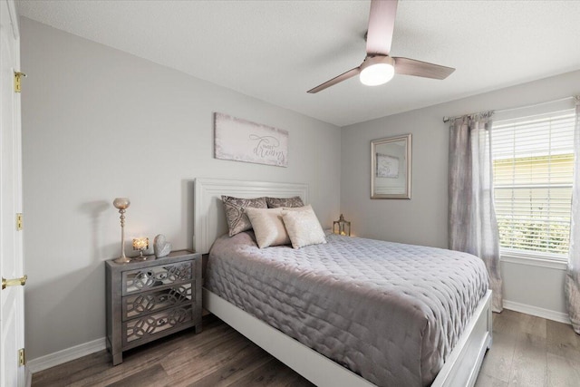 bedroom featuring ceiling fan and dark hardwood / wood-style flooring