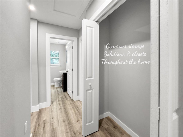 hallway with light hardwood / wood-style floors