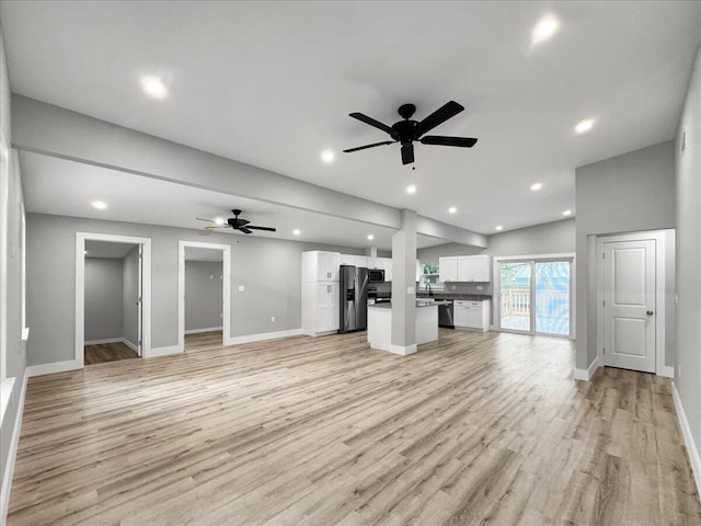 unfurnished living room with lofted ceiling, light hardwood / wood-style flooring, and ceiling fan