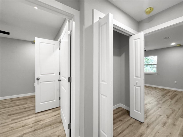 hall with light hardwood / wood-style flooring