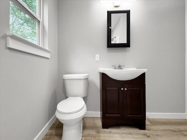 bathroom with vanity, hardwood / wood-style floors, and toilet