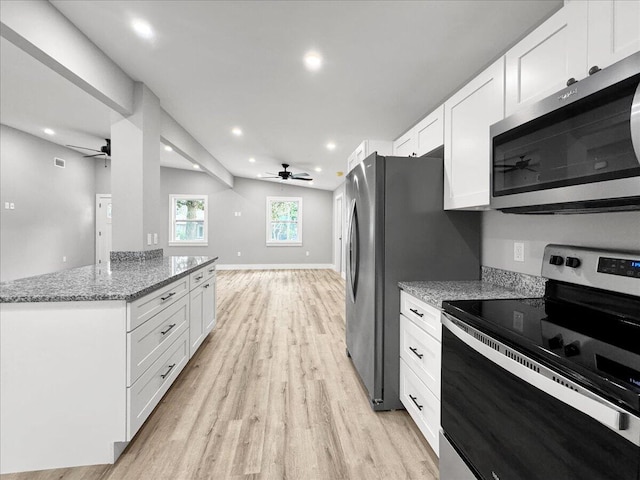 kitchen with light stone countertops, stainless steel appliances, light hardwood / wood-style floors, and white cabinets