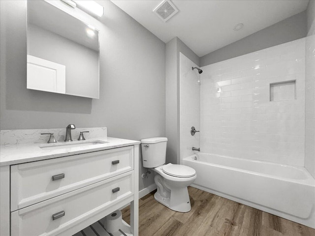 full bathroom with vanity, toilet, shower / bath combination, and hardwood / wood-style floors