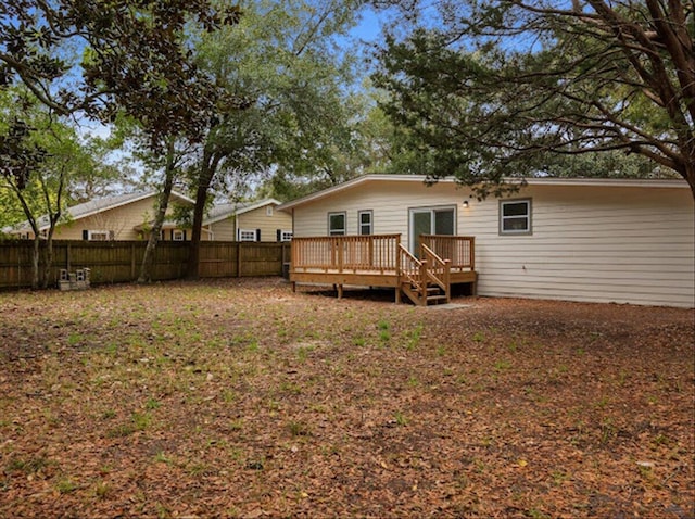 back of house with a wooden deck