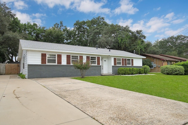 ranch-style home with a front lawn