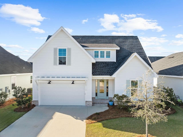 view of front facade featuring a front yard and a garage