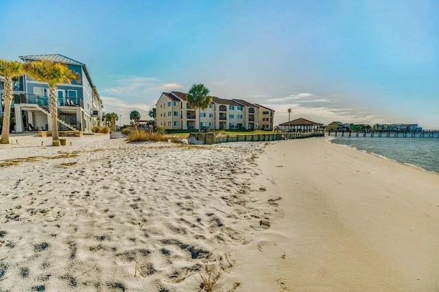 exterior space featuring a water view and a view of the beach