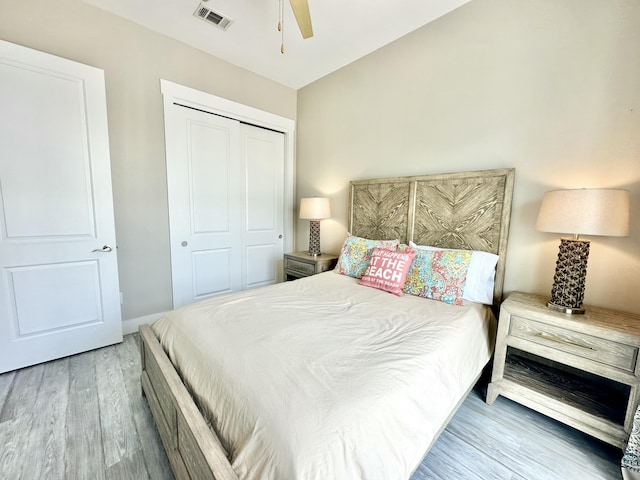 bedroom featuring wood-type flooring, a closet, and ceiling fan