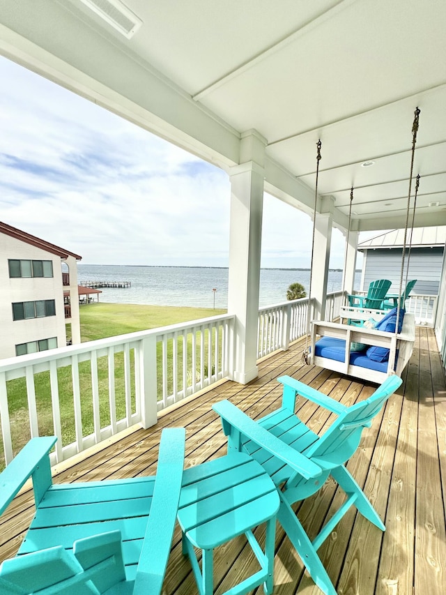 wooden deck with a water view