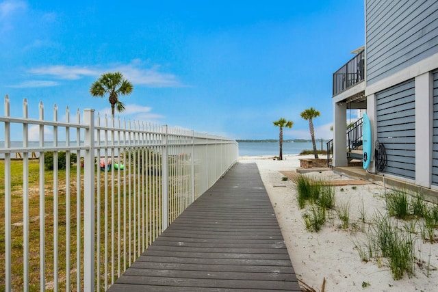 exterior space featuring a water view and a beach view