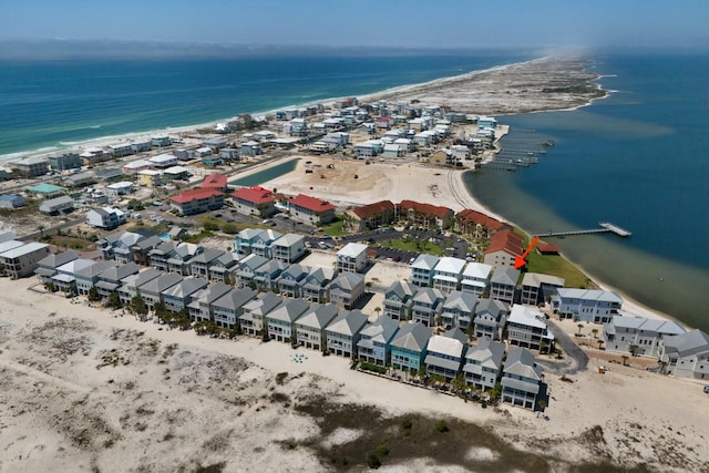 birds eye view of property featuring a water view and a beach view