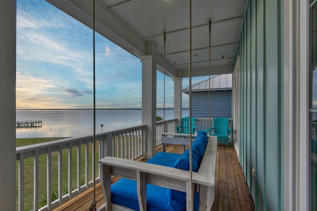 sunroom / solarium with a water view