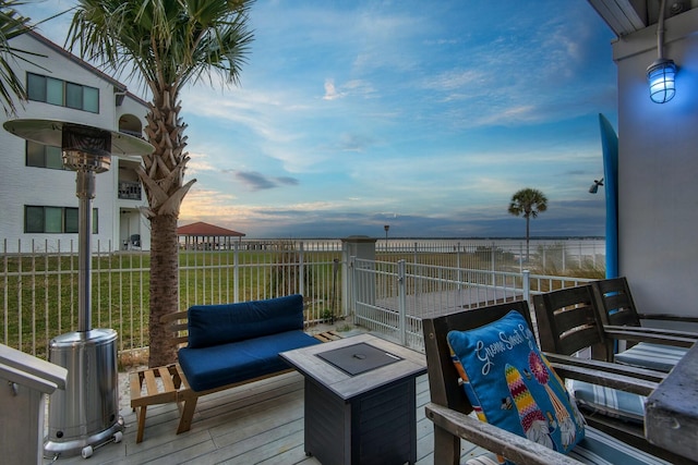 deck at dusk with an outdoor hangout area