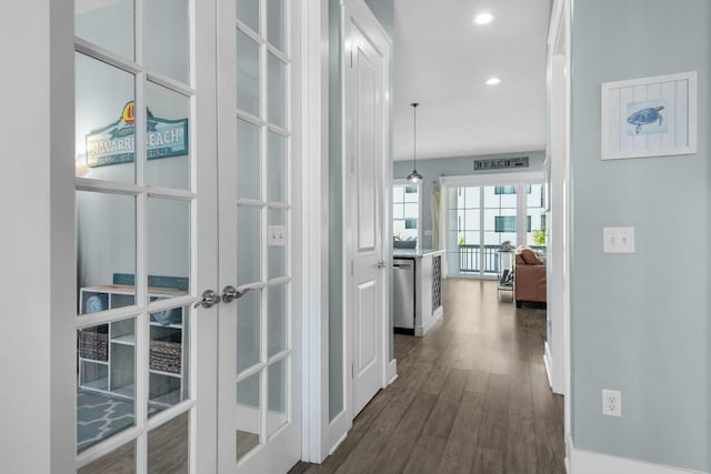 hall with dark hardwood / wood-style floors and french doors