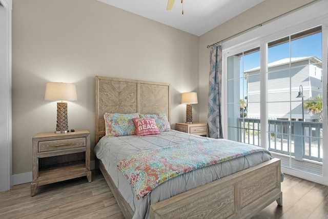 bedroom featuring access to exterior, ceiling fan, and light hardwood / wood-style flooring