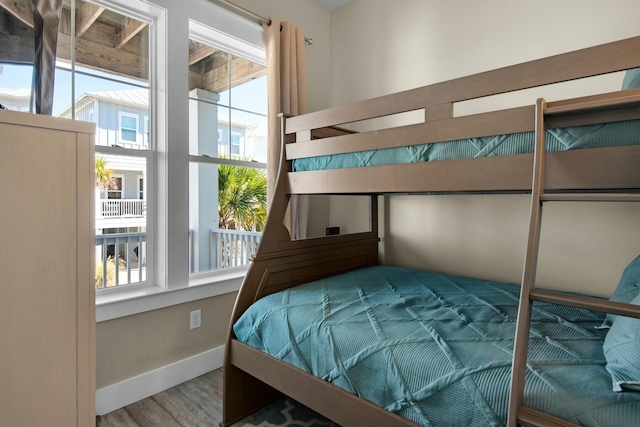 bedroom featuring multiple windows and wood-type flooring