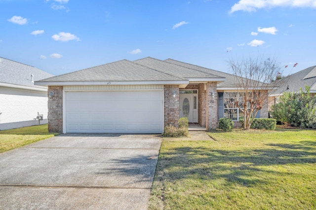 ranch-style house featuring a garage and a front lawn