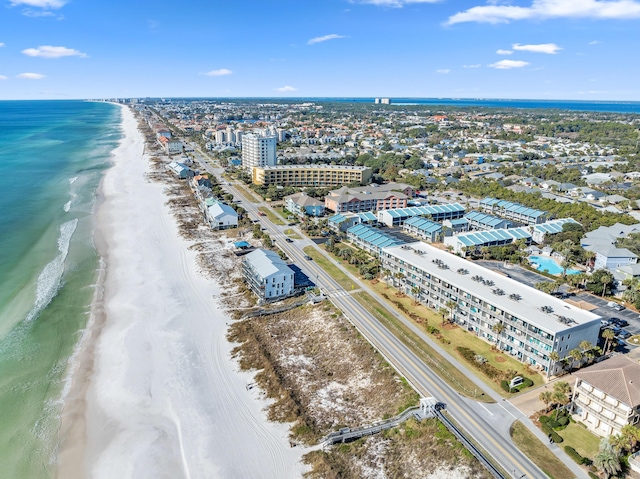 birds eye view of property featuring a water view and a beach view