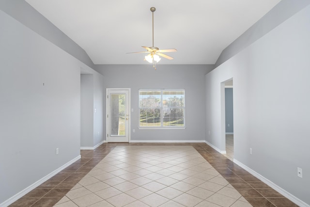 tiled empty room featuring vaulted ceiling and ceiling fan