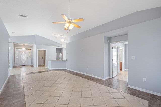 unfurnished living room with ceiling fan, light tile patterned flooring, and lofted ceiling