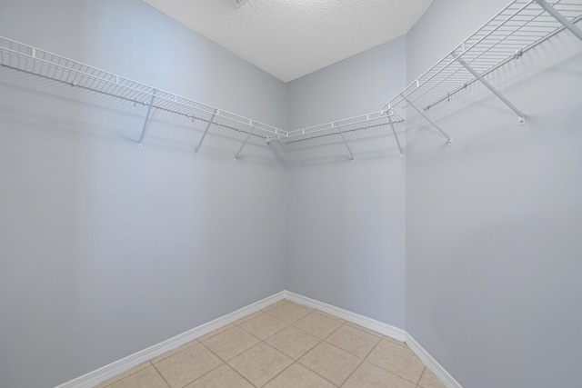 walk in closet with tile patterned floors